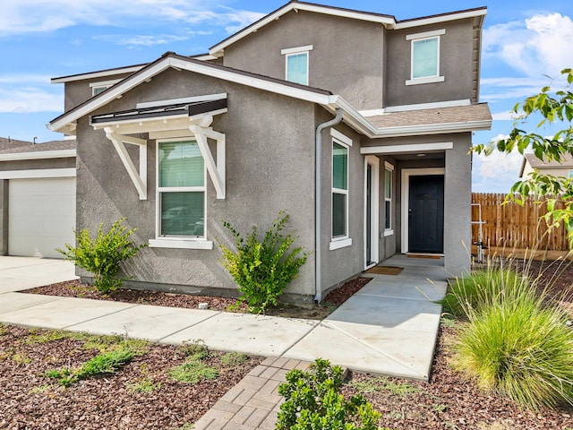 6018 Vespucci Ave, Bakersfield, CA 93313 - view of front of property with stucco siding and a garage