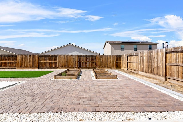 6018 Vespucci Ave, Bakersfield, CA 93313 - fenced backyard with a patio area and a vegetable garden