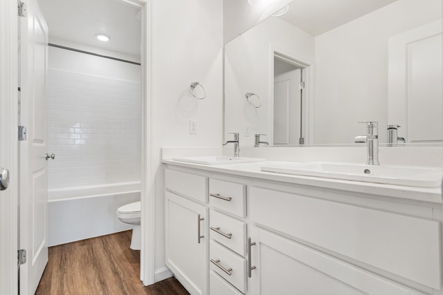 6018 Vespucci Ave, Bakersfield, CA 93313 - full bathroom with wood finished floors, toilet, double vanity, and bathing tub / shower combination