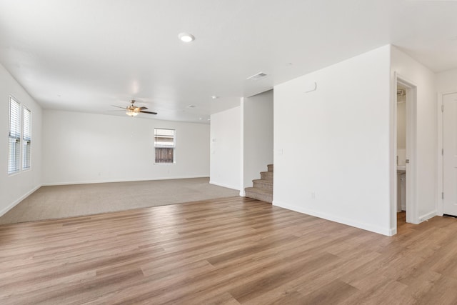 6018 Vespucci Ave, Bakersfield, CA 93313 - unfurnished living room featuring stairway, a ceiling fan, light wood finished floors, and baseboards