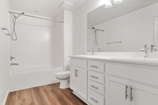6018 Vespucci Ave, Bakersfield, CA 93313 - full bathroom featuring wood finished floors, toilet, double vanity, and washtub / shower combination