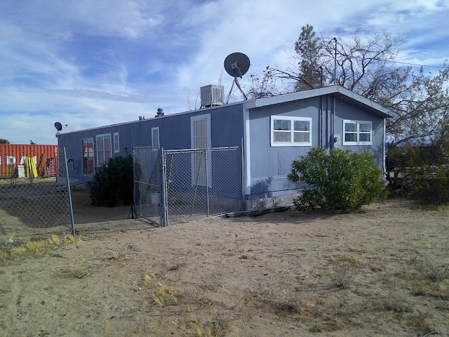 view of side of home featuring central AC