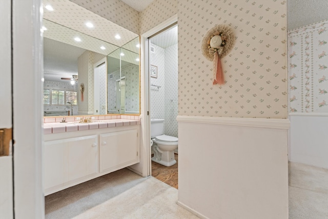 2600 Aland St, Lancaster, CA 93536 - bathroom featuring wallpapered walls, vanity, toilet, recessed lighting, and a ceiling fan