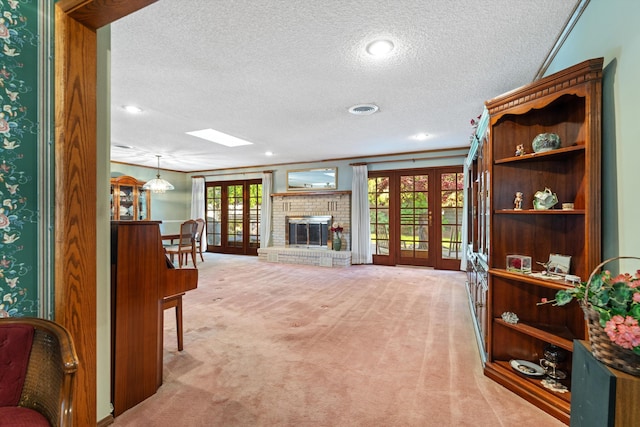 2600 Aland St, Lancaster, CA 93536 - living area with a textured ceiling, light carpet, french doors, a skylight, and a fireplace