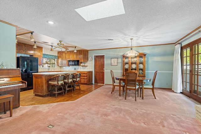 2600 Aland St, Lancaster, CA 93536 - dining room with light carpet, a textured ceiling, crown molding, a skylight, and recessed lighting