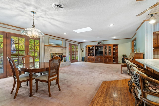 2600 Aland St, Lancaster, CA 93536 - dining space with ornamental molding, light carpet, plenty of natural light, a textured ceiling, and a chandelier