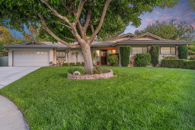 2600 Aland St, Lancaster, CA 93536 - ranch-style home featuring stone siding, a garage, concrete driveway, a yard, and stucco siding