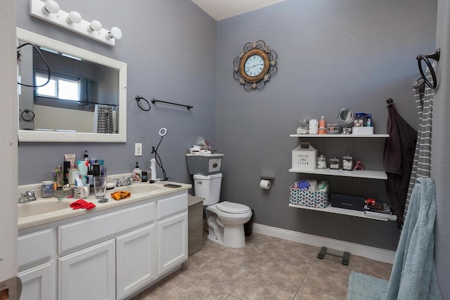 bathroom featuring tile patterned flooring, vanity, and toilet
