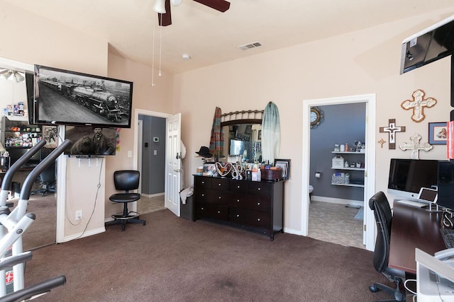 carpeted office space featuring ceiling fan