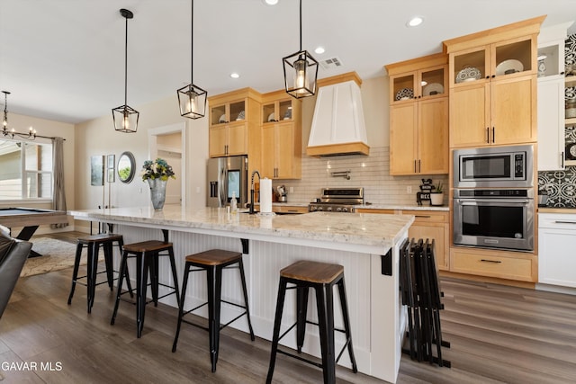 28380 Pimlico Way, Tehachapi, CA 93561 - kitchen featuring appliances with stainless steel finishes, custom range hood, backsplash, a spacious island, and dark wood-type flooring