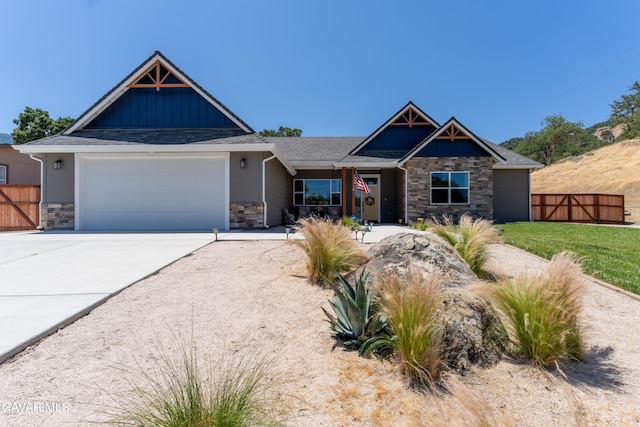 28380 Pimlico Way, Tehachapi, CA 93561 - craftsman house featuring stone siding, an attached garage, board and batten siding, and driveway