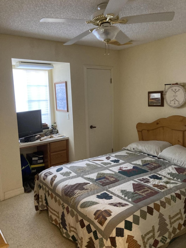 bedroom with ceiling fan and a textured ceiling