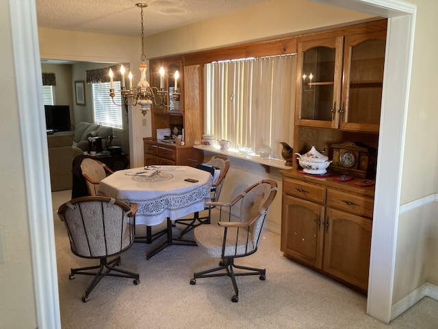 carpeted dining space featuring a textured ceiling and a notable chandelier