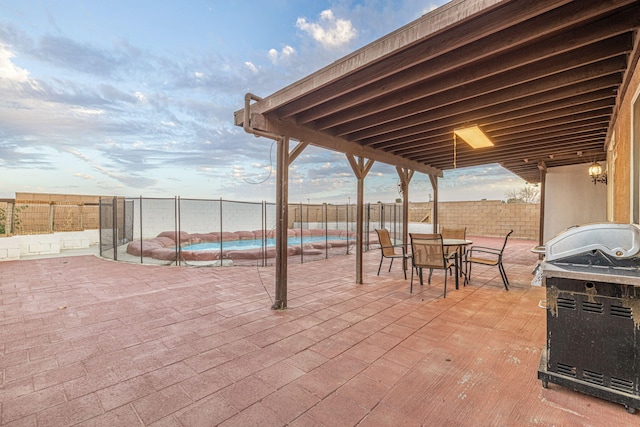 view of patio with a fenced backyard, outdoor dining area, and a fenced in pool