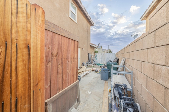 view of property exterior with a patio area, a fenced backyard, and stucco siding