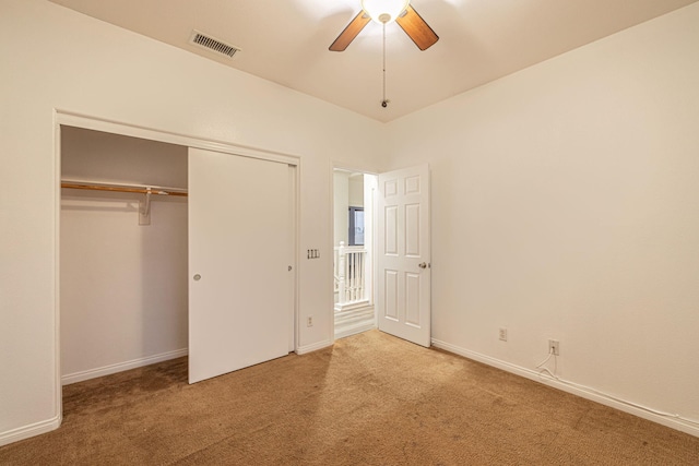 unfurnished bedroom with carpet, a closet, visible vents, and baseboards