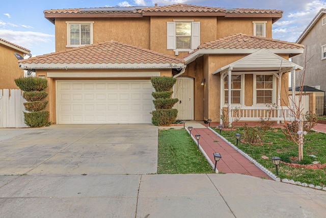 mediterranean / spanish-style home with a garage, concrete driveway, a tiled roof, a porch, and stucco siding