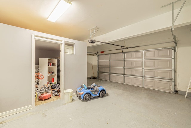 garage featuring baseboards and a garage door opener