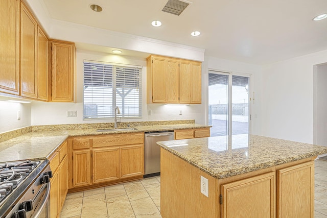 kitchen with appliances with stainless steel finishes, visible vents, a sink, and light stone counters
