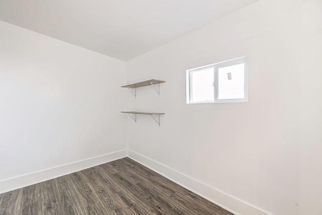 interior space with dark wood-style flooring and baseboards