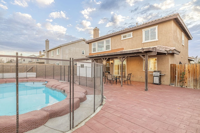 view of swimming pool with a fenced backyard, a patio, a fenced in pool, and area for grilling