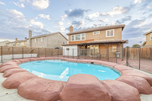 view of pool with a patio area, a fenced backyard, and a fenced in pool