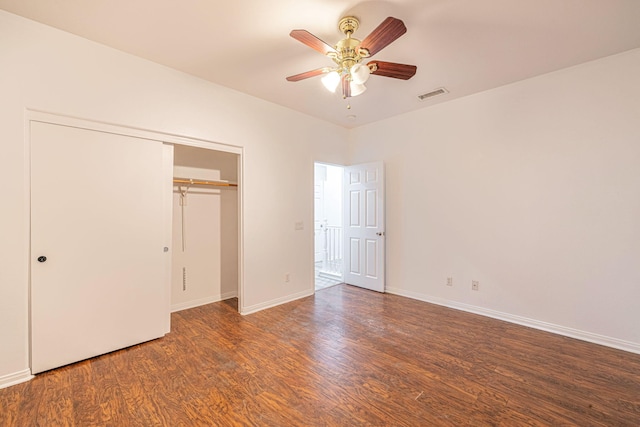 unfurnished bedroom featuring a closet, visible vents, baseboards, and wood finished floors