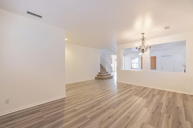 interior space with stairs, light wood-style flooring, and visible vents
