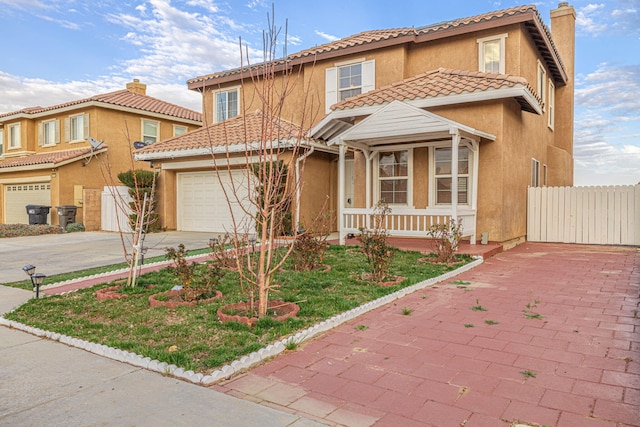 mediterranean / spanish-style house featuring a garage, a tile roof, fence, and driveway