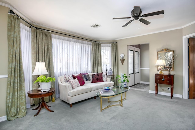 living room featuring crown molding, carpet flooring, and ceiling fan