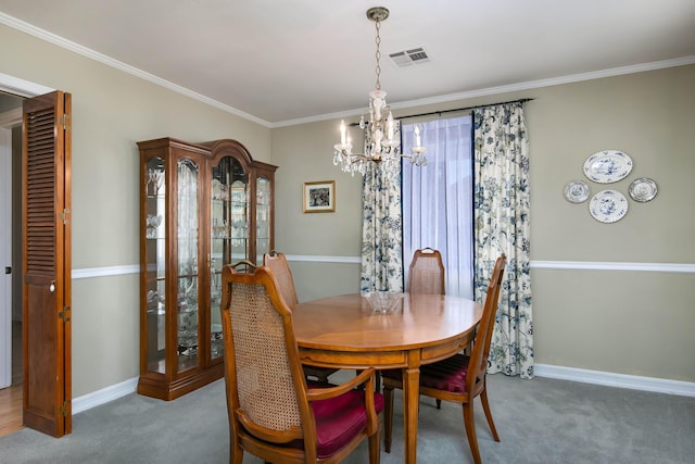 dining space with ornamental molding, carpet flooring, and a chandelier