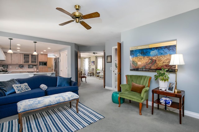 living room with light carpet and ceiling fan