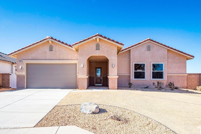 40127 Pevero Ct, Palmdale, CA 93551 - mediterranean / spanish house featuring stucco siding, concrete driveway, a garage, and a tiled roof