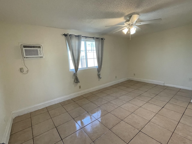 2010 W Lumber St, Lancaster, CA 93536 - spare room with a textured ceiling, a wall mounted air conditioner, light tile patterned floors, ceiling fan, and baseboards