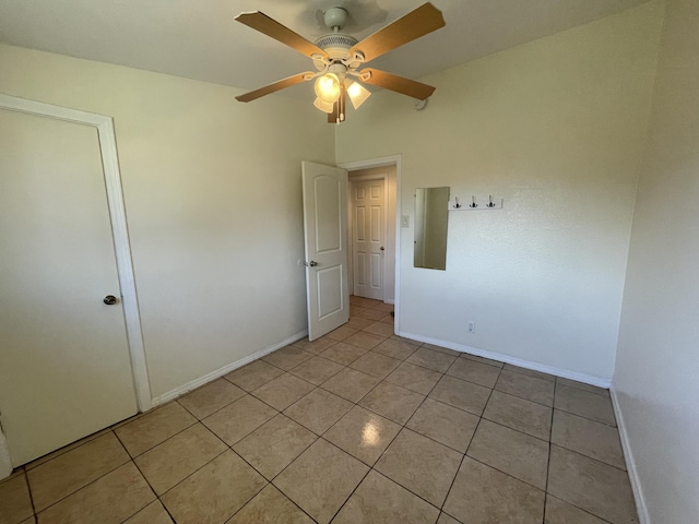 2010 W Lumber St, Lancaster, CA 93536 - unfurnished bedroom with baseboards, light tile patterned floors, and a ceiling fan