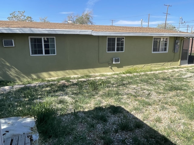 2010 W Lumber St, Lancaster, CA 93536 - rear view of house featuring stucco siding, a lawn, and a shingled roof