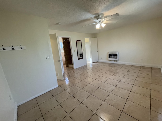 2010 W Lumber St, Lancaster, CA 93536 - unfurnished room with heating unit, ceiling fan, light tile patterned floors, a textured ceiling, and baseboards