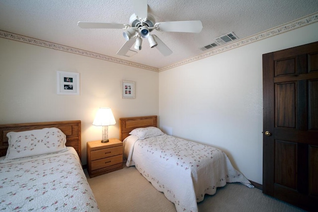 21561 Sheridan Ct, California City, CA 93505 - bedroom with visible vents, a textured ceiling, ceiling fan, and light carpet