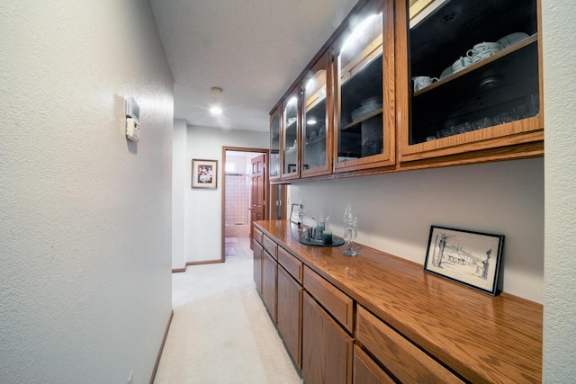 21561 Sheridan Ct, California City, CA 93505 - hall featuring baseboards, a textured wall, and light carpet