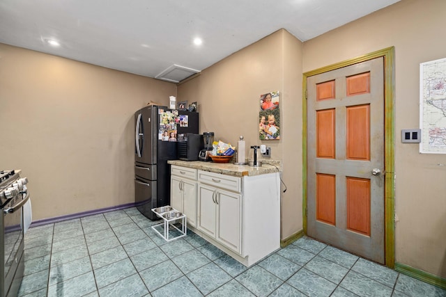 kitchen featuring white cabinets and appliances with stainless steel finishes