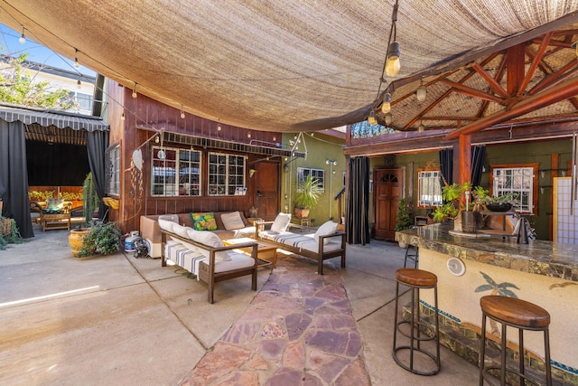 view of patio / terrace with a bar and an outdoor hangout area