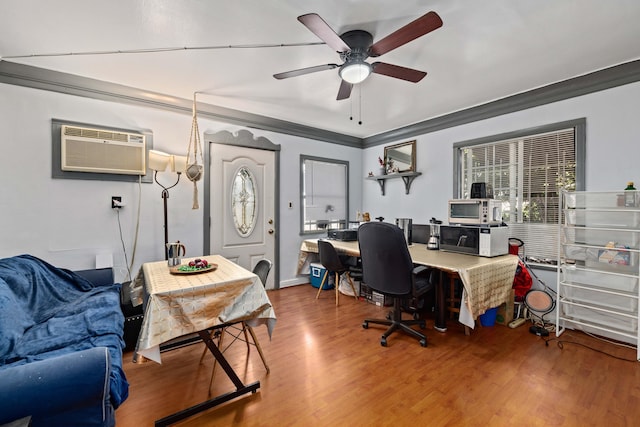 office space with ceiling fan, crown molding, wood-type flooring, and a wall mounted air conditioner