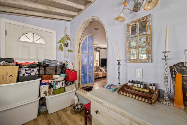 interior space featuring vaulted ceiling with beams and hardwood / wood-style floors