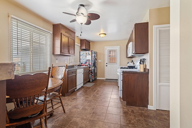 206 Brentwood Dr, Tehachapi, CA 93561 - kitchen featuring a sink, dark countertops, baseboards, white appliances, and a ceiling fan