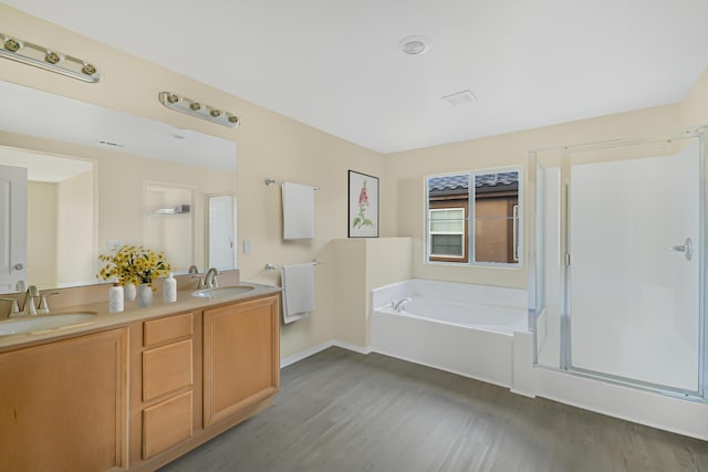 bathroom with separate shower and tub, vanity, and hardwood / wood-style floors