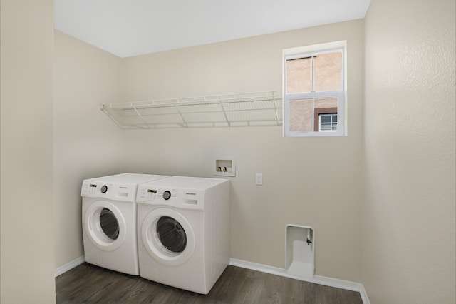 clothes washing area featuring washer and dryer and dark hardwood / wood-style floors