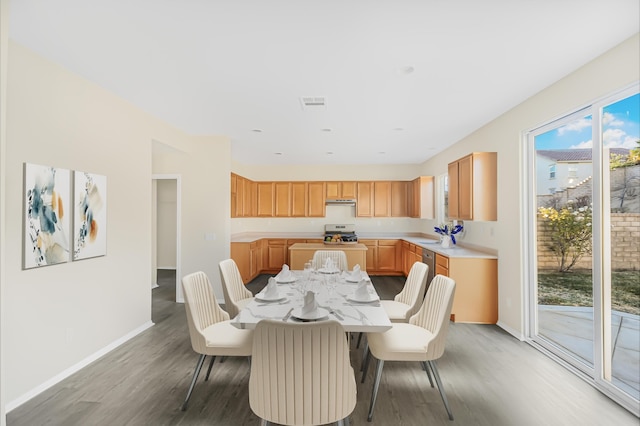 dining area with hardwood / wood-style floors and sink