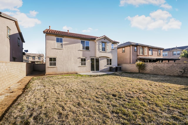 rear view of property with a yard