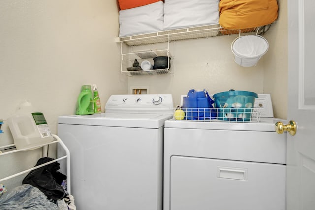 clothes washing area with washing machine and clothes dryer and laundry area