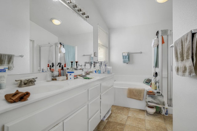 bathroom with double vanity, a sink, a bath, and a shower stall